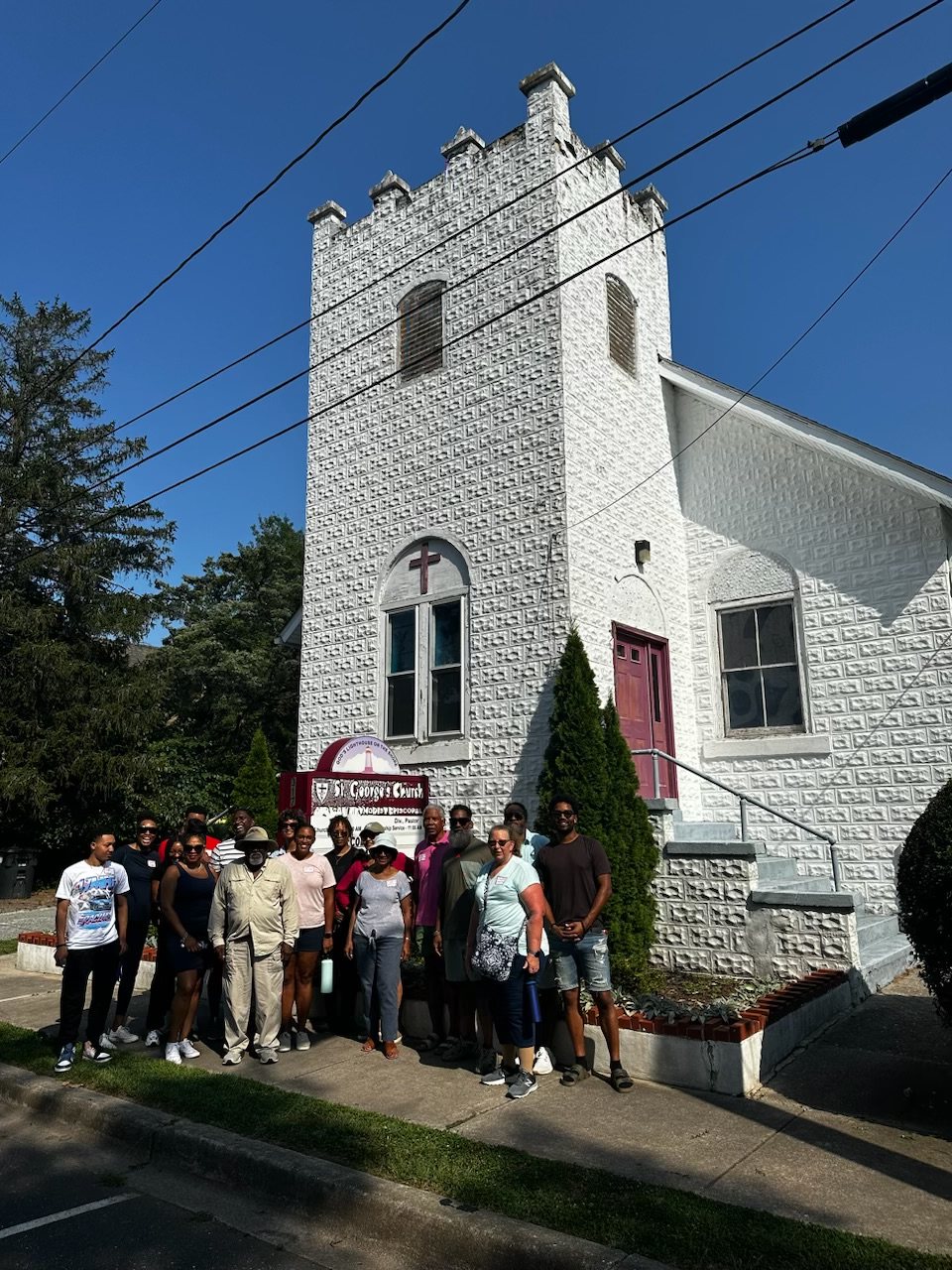 Family group at a white church with a steeple